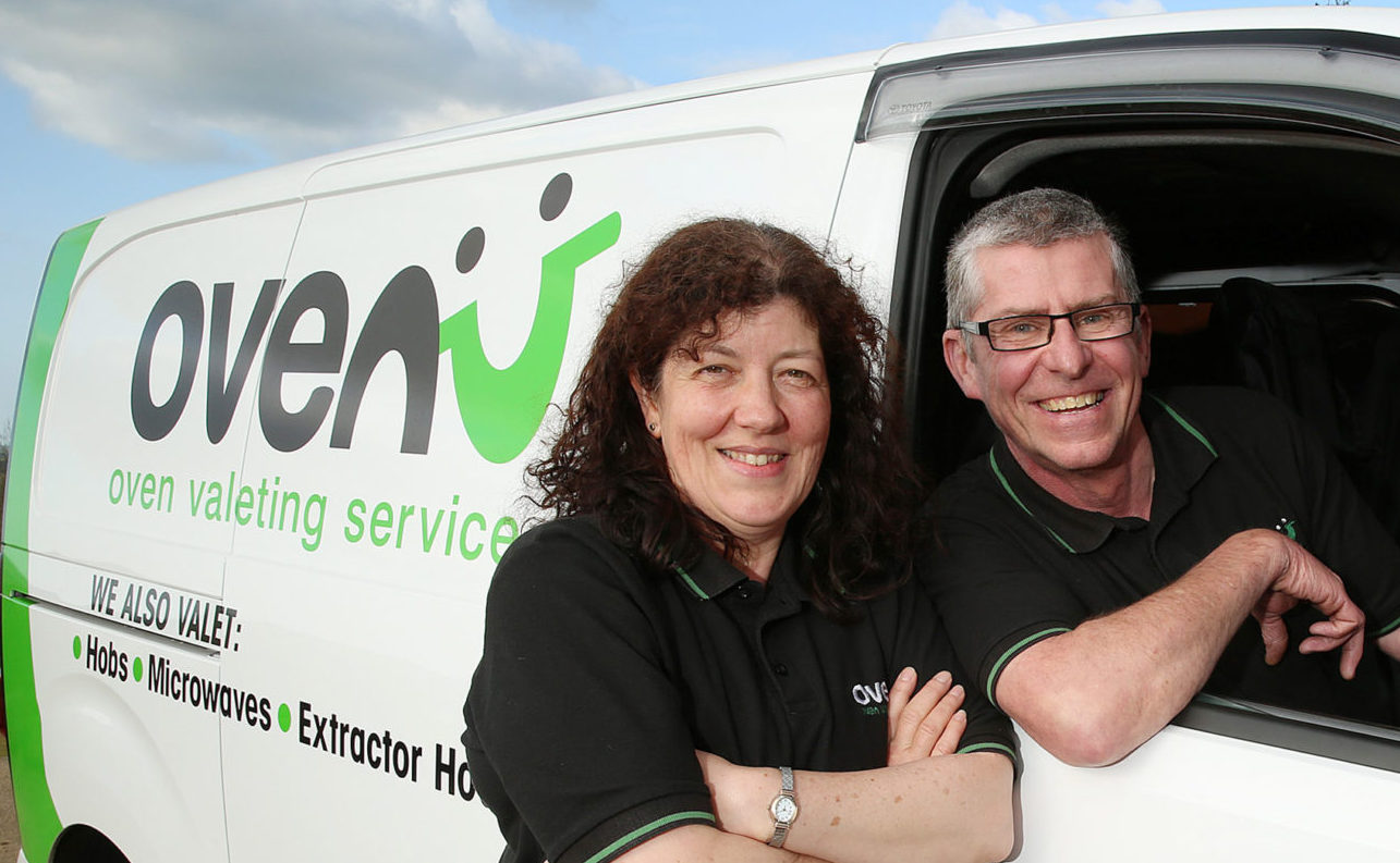 Professional oven cleaners in a van